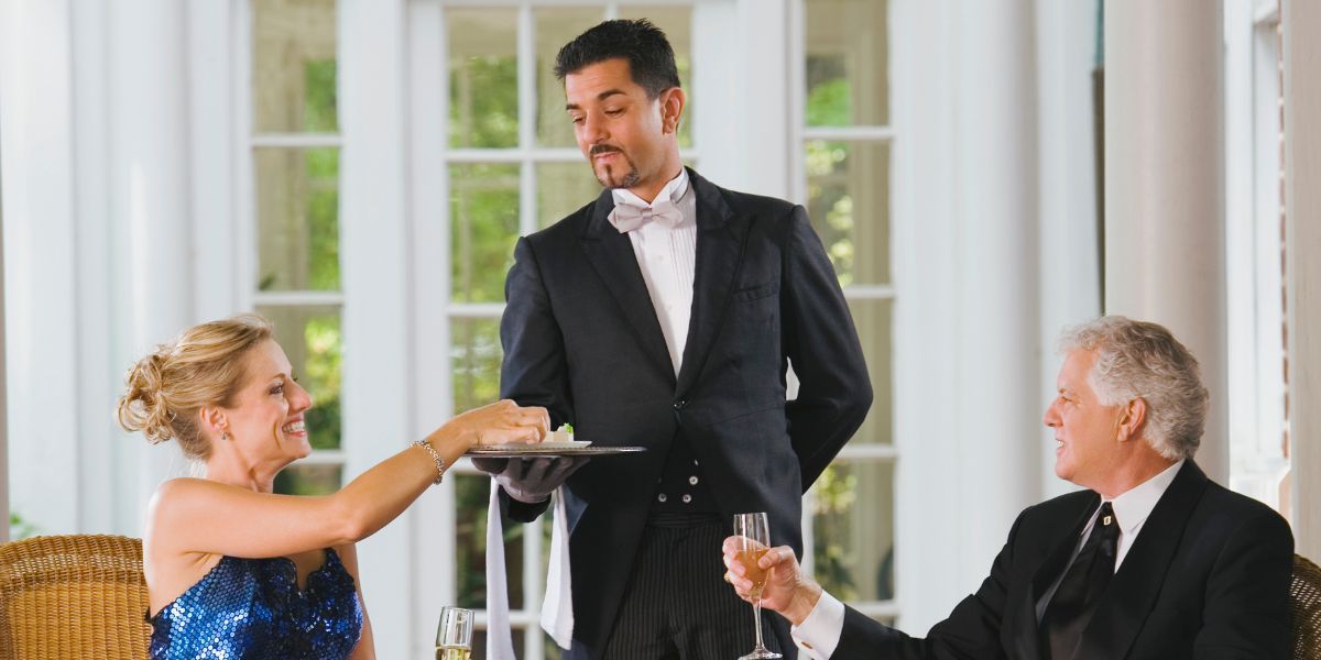 butler serving couple
